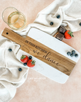 Acacia wood and marble charcuterie or serving board with engraving "in this kitchen we dance" on wood. Engraved and sold by Like No Otter Design Co