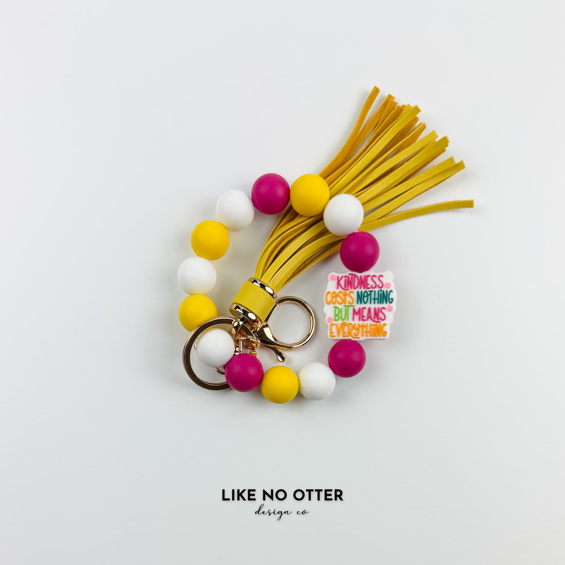 Magenta, Yellow & White Kindness Costs Nothing but Means Everything Silicone Wristlet
